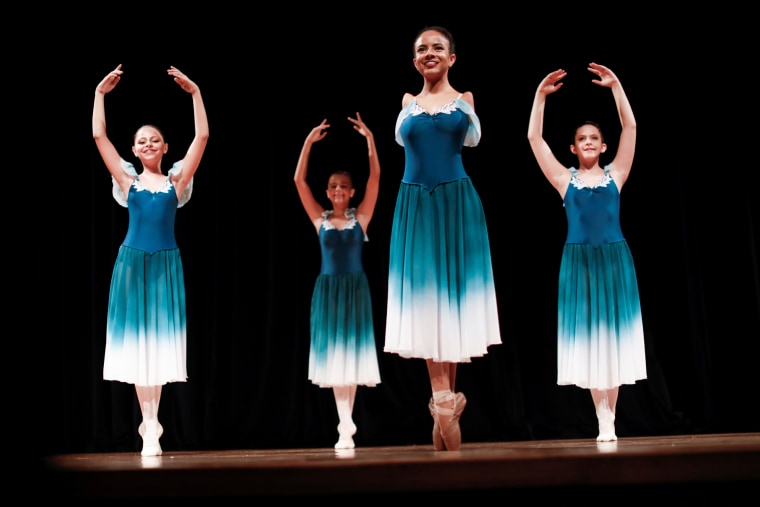 Image: Vitoria Bueno, a 16-year-old dancer whose genetic condition left her without arms, performs with her teammates from the Andrea Falsarella ballet academy on stage at the Inatel Theater in Santa Rita do Sapucai