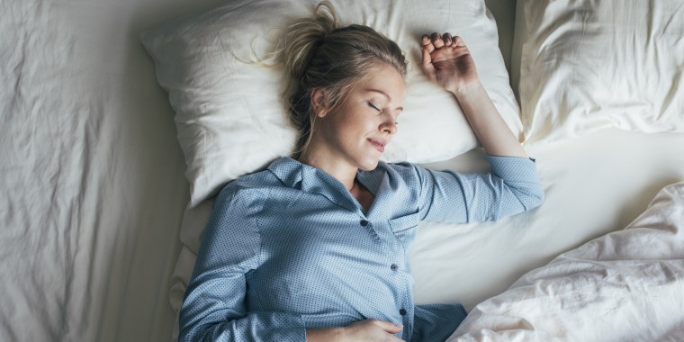 Sound Asleep: Overhead Waist Up Shot of a Pretty Blonde Woman in Blue Pyjamas Sleeping on a King Size Bed