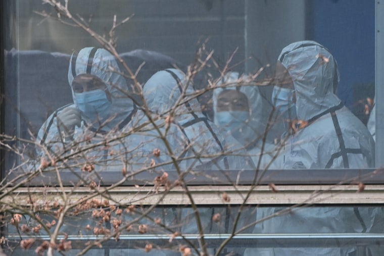Image: Members of the World Health Organization team investigating the origins of the Covid-19 coronavirus, wearing protective gear are seen during their visit to the Hubei Center for animal disease control and prevention in Wuhan, China's central Hubei p