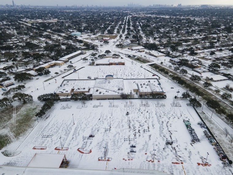 Image: A Home Depot parking lot is covered in snow in the Westbury neighborhood of Houston on Monday.