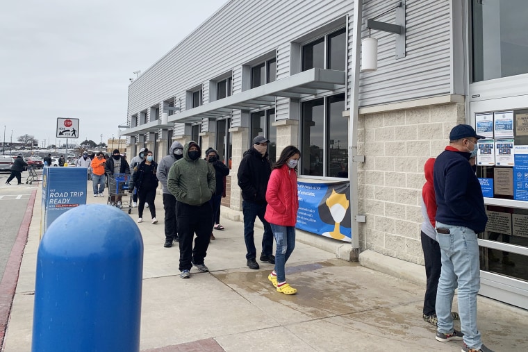 Amid cold temperatures, people wait in line outside a Walmart in San Antonio, Texas, on Feb. 16, ,2021.