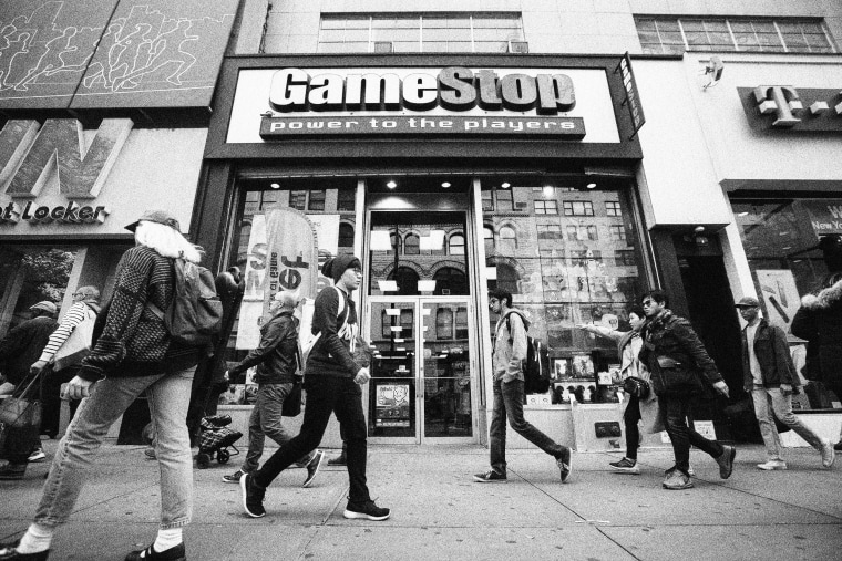 Image: Pedestrians walk past a GameStop Corp. store in New York.