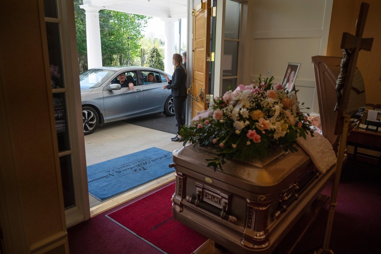 Image: An attendee drives past during a viewing for Mrs. Barbara Lipscomb at the Fellows, Helfenbein &amp; Newnam Funeral Home in Centreville, Md.