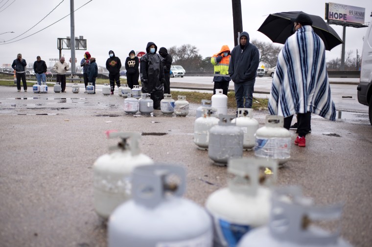 Propane tanks are placed in a line as people wait for the power to turn on to fill their tanks in Houston on Feb. 17, 2021.