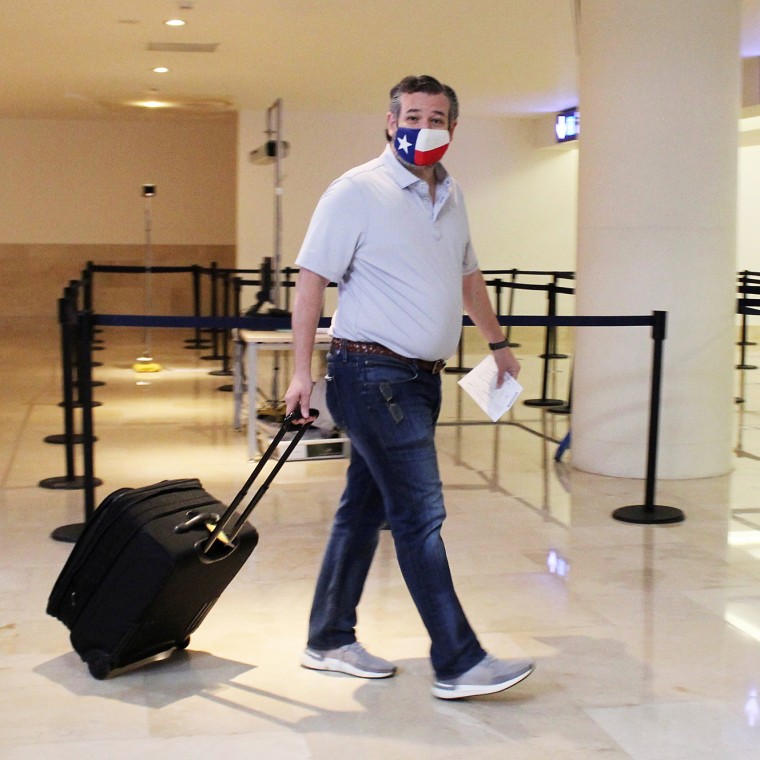 Image: U.S. Senator Ted Cruz (R-TX) carries his luggage at the Cancun International Airport before boarding his plane back to the U.S., in Cancun