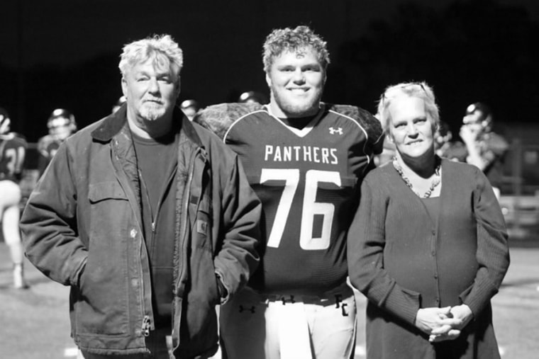 Image: Kim Johnson and her husband Delbert with their son Sam at a high school football game in November 2016.