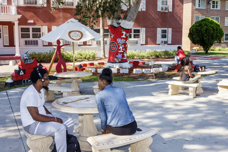 Students sitting outside Flora B. Curtis Hall at Bethune-Cook University.