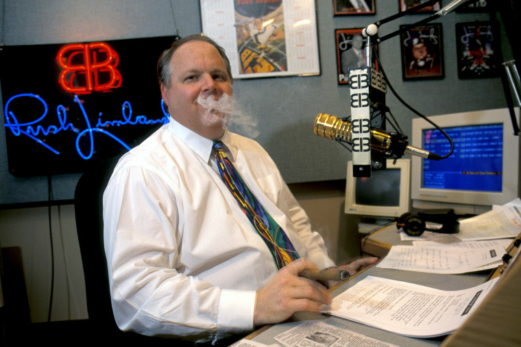 Conservative radio talk show host Rush Limbaugh takes a break and smokes a cigar during his radio show.