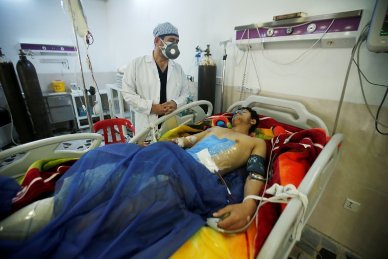 Image: A man is treated at a hospital after he was injured in a rocket attack on U.S.-led forces in and near Irbil International Airport