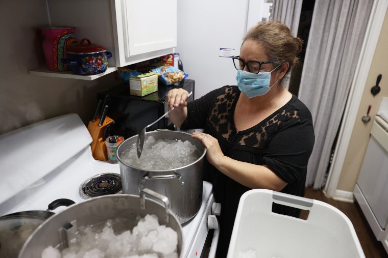 Image: Marie Maybou melts snow on the kitchen stove in Austin, Texas.