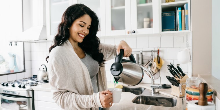 Young adult woman filling a cup of coffee