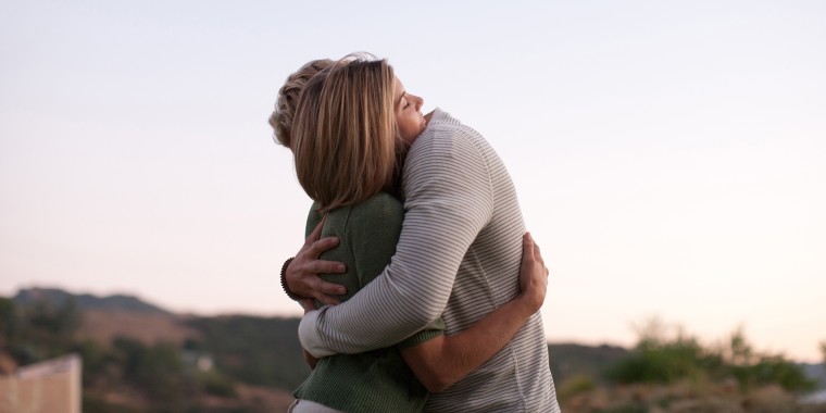 Couple hugging outdoors