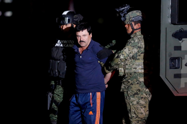 Image: Joaquin \"El Chapo\" Guzman is escorted by soldiers during a presentation in Mexico City