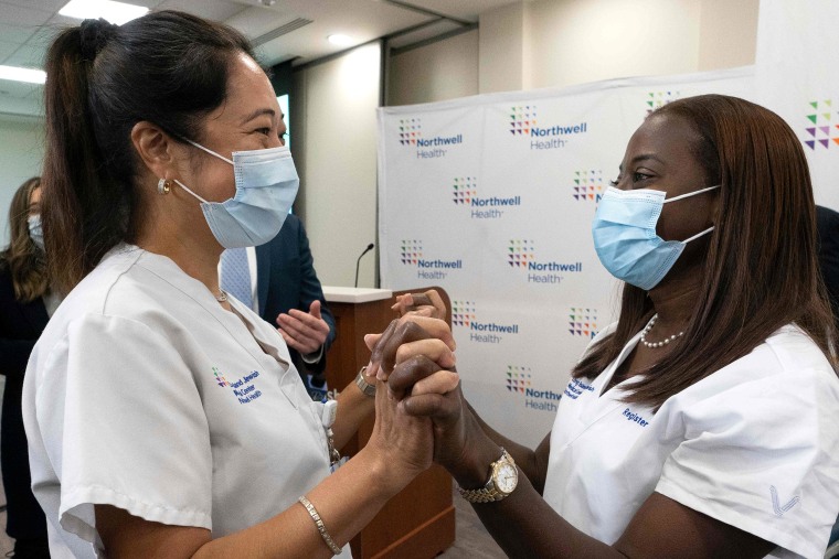 Image: From left, Nurse Annabelle Jimenez congratulates nurse Sandra Lindsay after she is inoculated with the Covid-19 vaccine, at Long Island Jewish Medical Center, in Queens, New York on Dec . 14, 2020