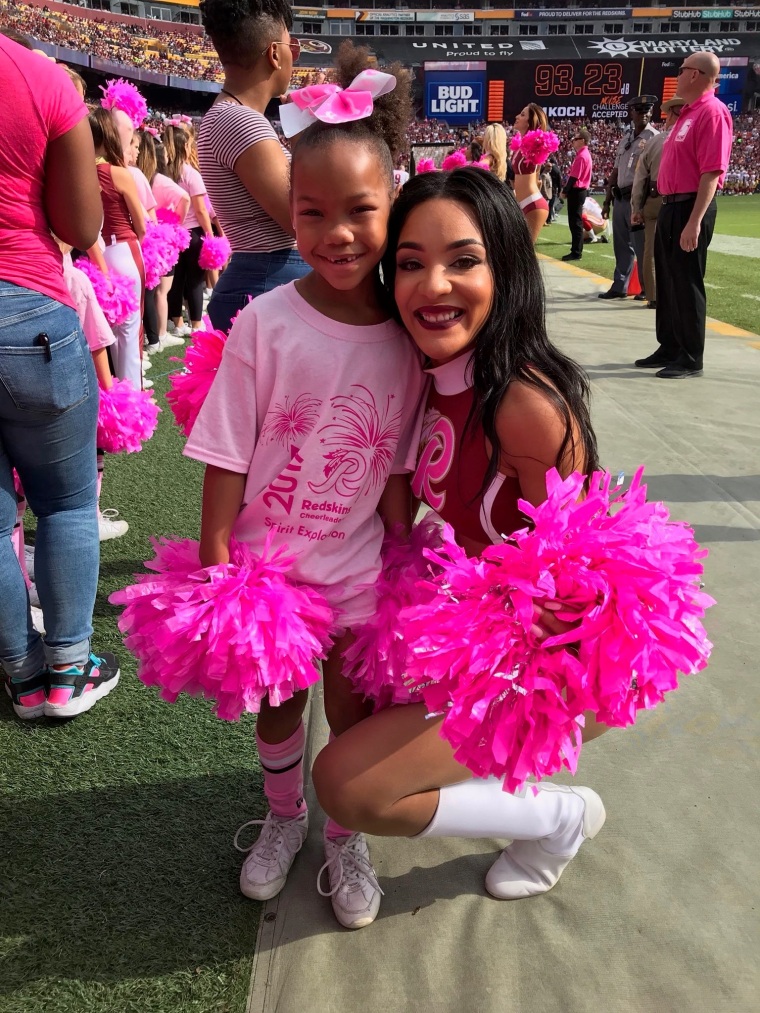 Shannon Shepherd, a former Washington Football Team cheerleader with a fan. Shepherd also works full-time as a criminal paralegal.