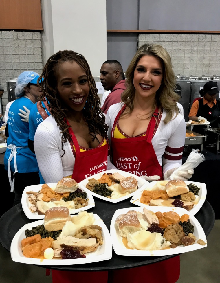 Erica Hanner, right, and another former Washington Football Team cheerleader at an event in November 2018 to help serve families in need in the Washington D.C.-area.