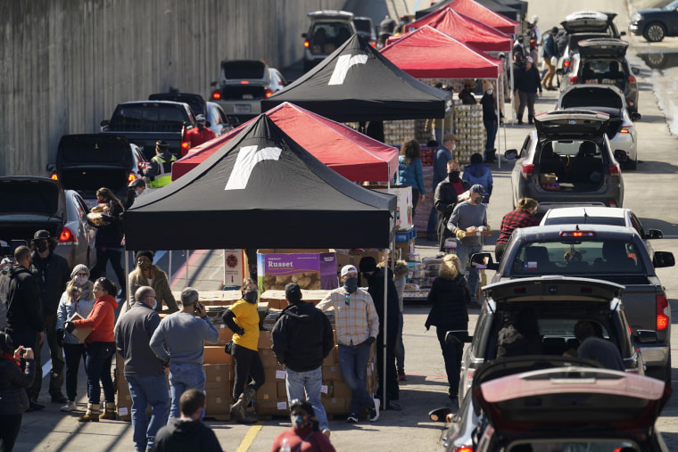 Image: Volunteers hand out food and water at a San Antonio Food Bank drive-through food distribution site