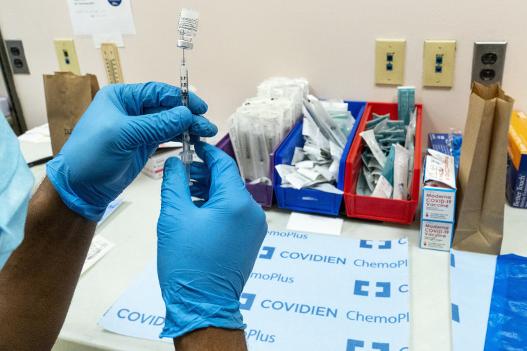 Image: Pharmacist handles syringe with Pfizer vaccine