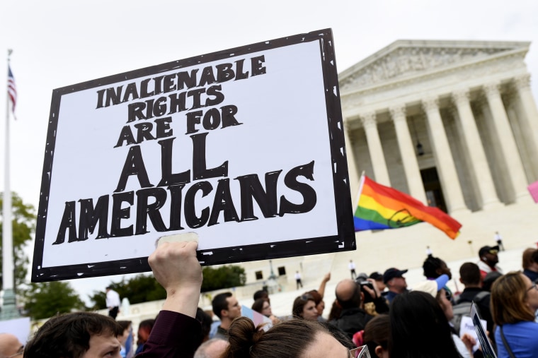 Protesters gather outside the Supreme Court in Washington where the Supreme Court is hearing arguments in the first case of LGBT rights on Oct. 8, 2019.