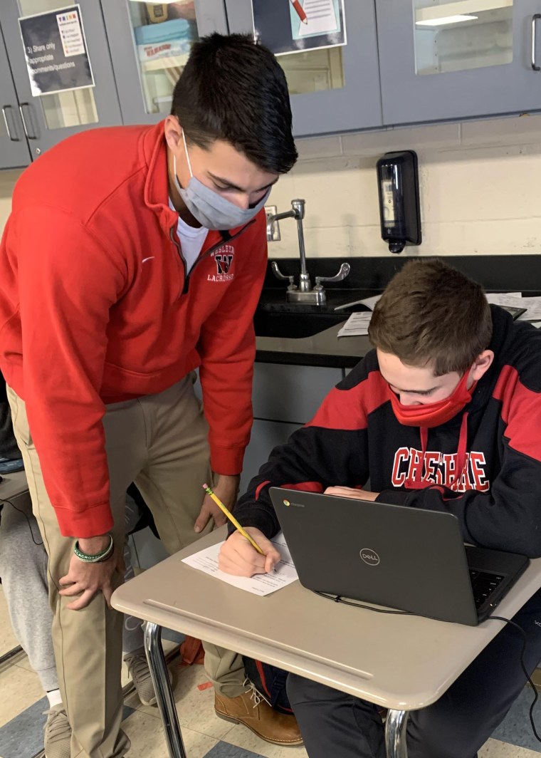 IMage: Jack Raba, a recent Cheshire Public Schools graduate, works with seventh grader Cody Persico at Dodd Middle School. Raba is one of about 50 graduates who answered the superintendent's appeal to help out by substitute teaching during the pandemic.