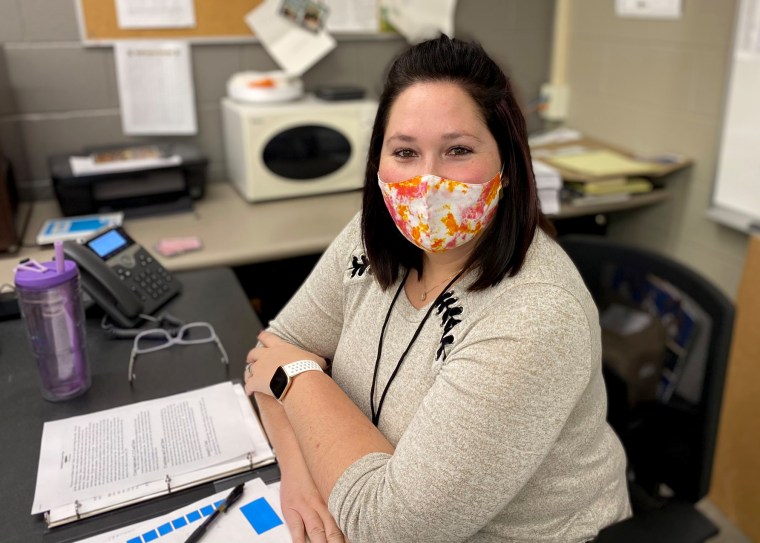 Image: Stefanie Fernandez works for a company that has encouraged its employees to substitute teach in local schools. Armed with a binder of "sub notes," she's filling in for an absent teacher in the computer lab at Lebanon, Mo., Middle School.