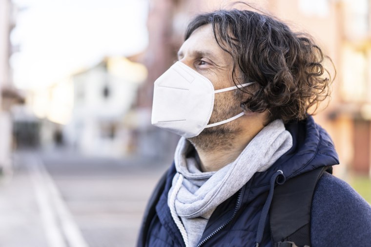 MIddle age man wearing in EU obligatory FFP2/KN95/N95/ protective mask