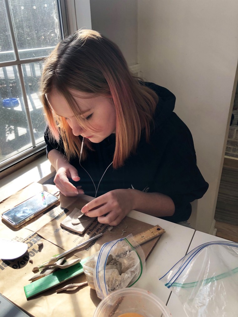 Oona, 14, works on an art project in her home in Charlotte, N.C.