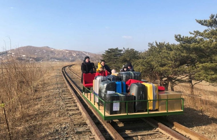 Image: Russian diplomats and family members leave North Korea to Russia using a hand-pushed rail trolley due to Pyongyang's coronavirus restrictions
