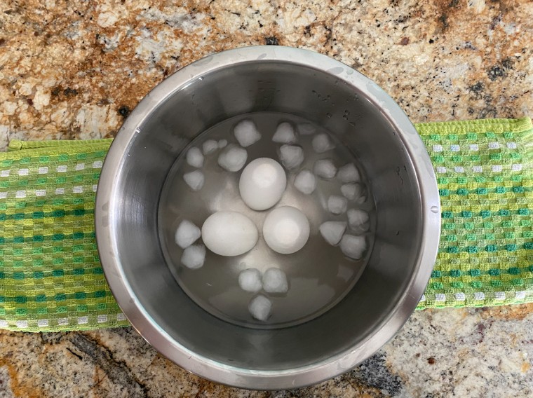 After the air fryer, the eggs get transferred to an ice bath to cool before peeling.