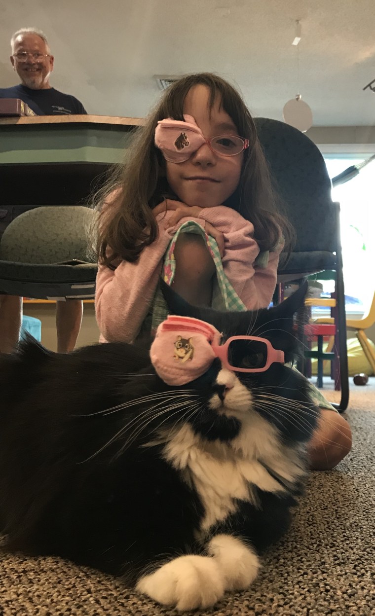 Truffles and a young girl wear eye patches.