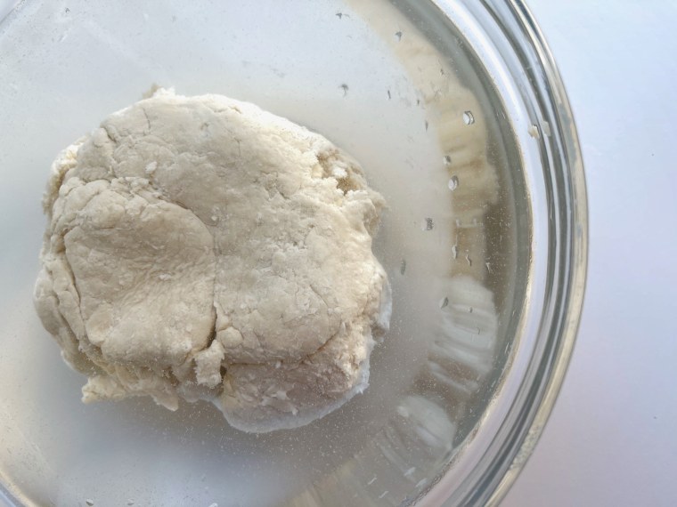 Put the dough in a bowl of cool water for at least an hour to allow the gluten to form.