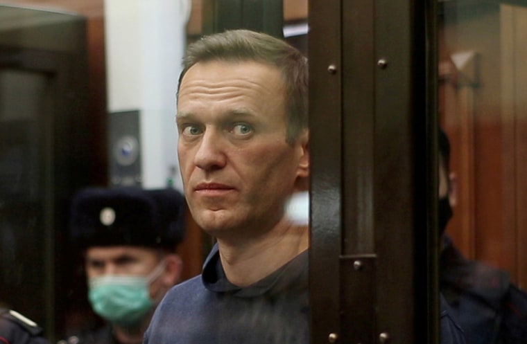 Image: Russian opposition leader Alexei Navalny, who is accused of flouting the terms of a suspended sentence for embezzlement, inside a defendant dock during the announcement of a court verdict in Moscow, Russia