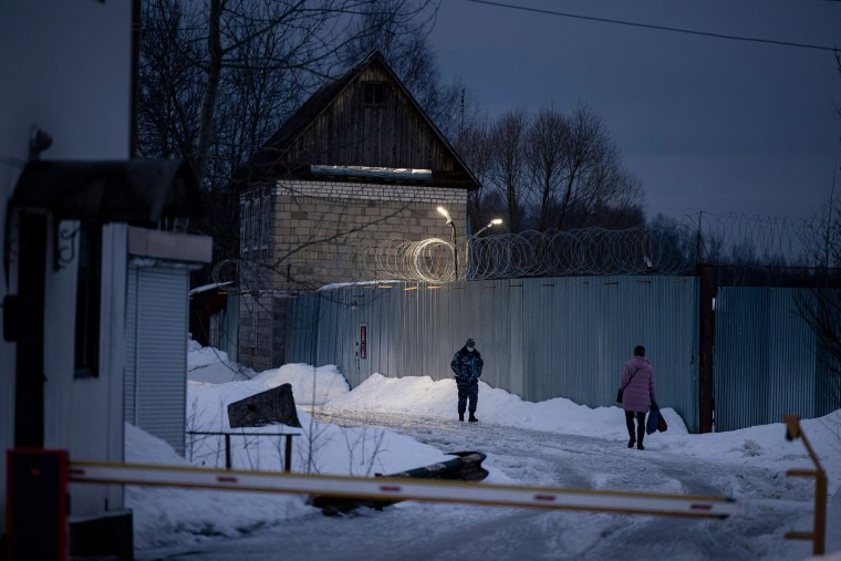 Image: An officer of the Russian Federal Penitentiary Service walks near the gate of the penal colony N2, where Kremlin critic Alexei Navalny has been transferred to serve a two-and-a-half year prison term for violating parole, in the town of Pokrov o