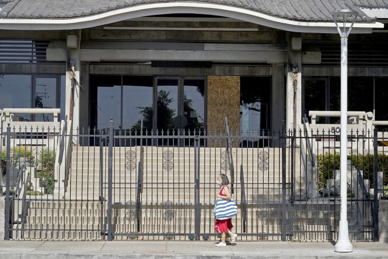 Image: A pedestrian walks past the closed Higashi Honganji Buddhist Temple in Los Angeles, on Feb. 27, 2021.