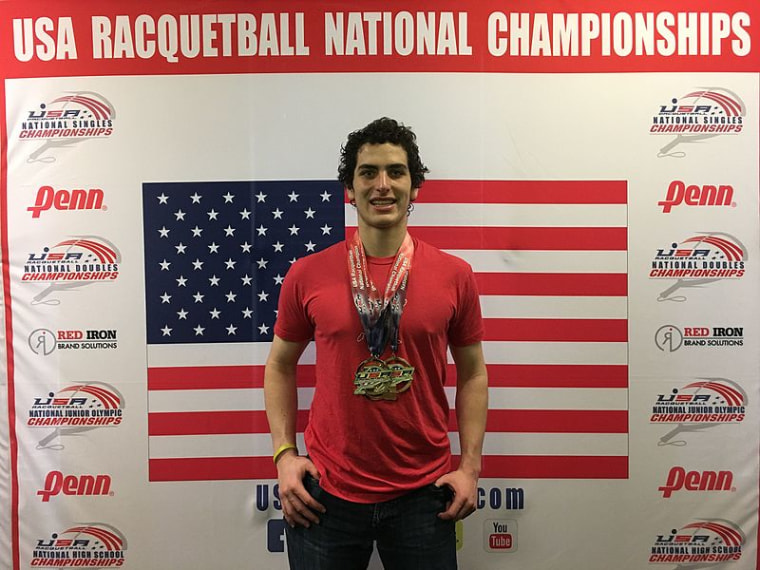 Dane Elkins with his medals from a racquetball championship in 2017.