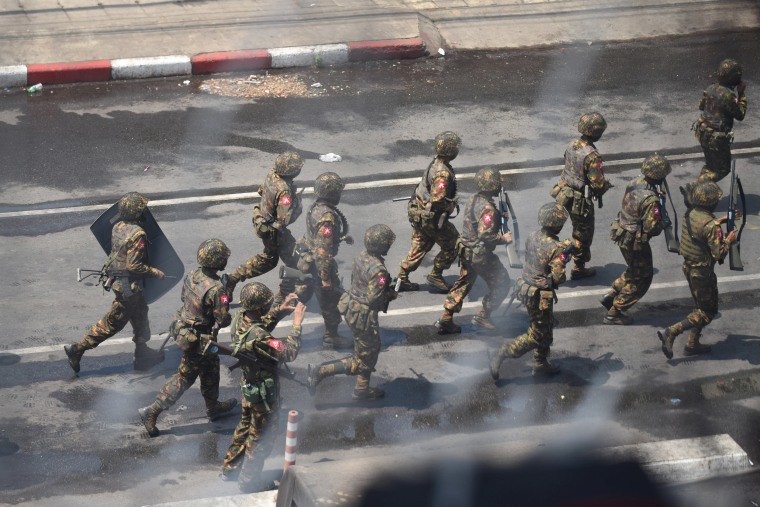 Image: Army officers intervene during a protest against the military coup in Yangon, Myanmar