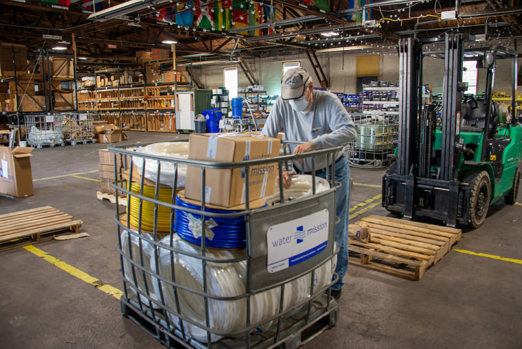 A man packs up a plumbing supplies shipment leaving Water Mission's Charleston, S.C., headquarters.