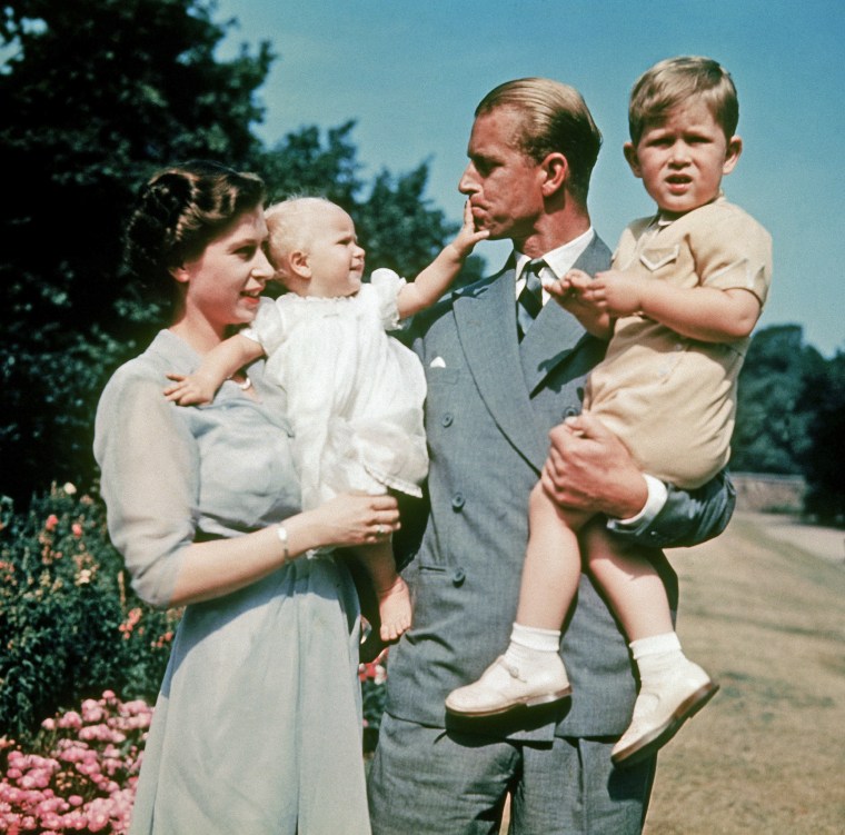 Image: Princess Anne in the arms of her mother Queen Elizabeth II while Prince Philip holds Prince Charles in 1951.
