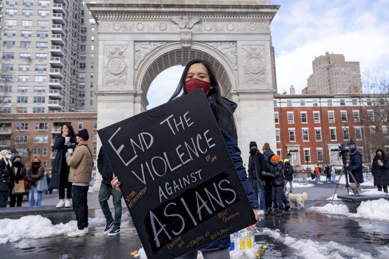 A woman holds a sign at the End The Violence Towards Asians rally in Washington Square Park on Feb. 20, 2021 in New Yor.