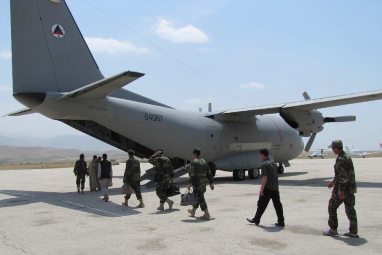 Image:  Afghan military personnel board a G222 in  May 2010.