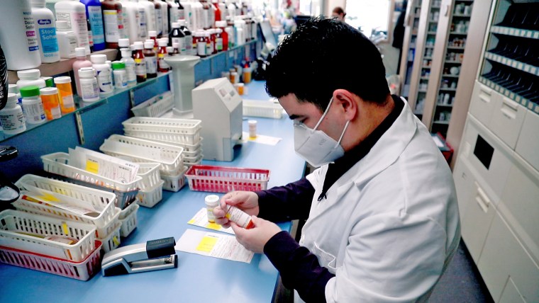 IMAGE: Shane Jerominski at work in his pharmacy.