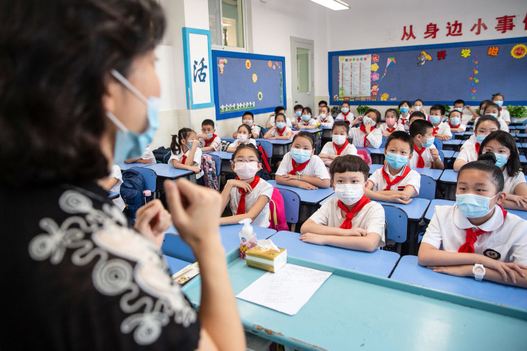 Image: Elementary school students attending a class on the first day of the new semester in Wuhan in China's central Hubei province.