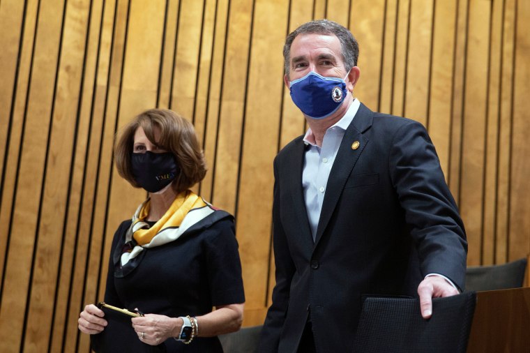 Virginia Governor Ralph Northam and his wife, Pamela Northam, arrive to watch first Lady Jill Biden participates in a panel discussion on cancer research and care at the Massey Cancer Center at Virginia Commonwealth University in Richmond, Va., on Feb. 24