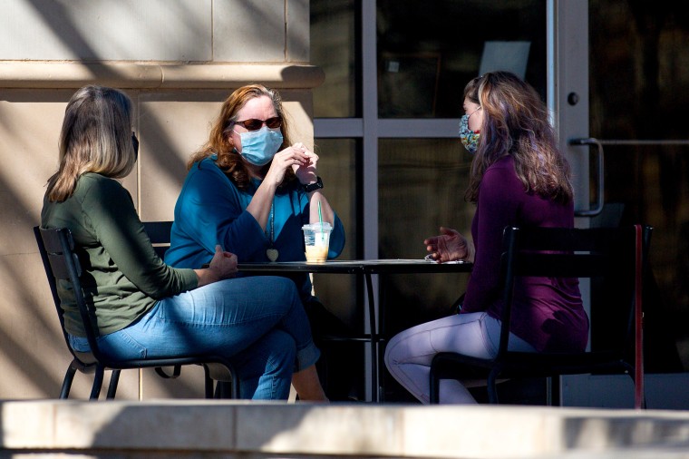 Image: Customers sit outside of Starbucks on March 3, 2021 in Austin, Texas.