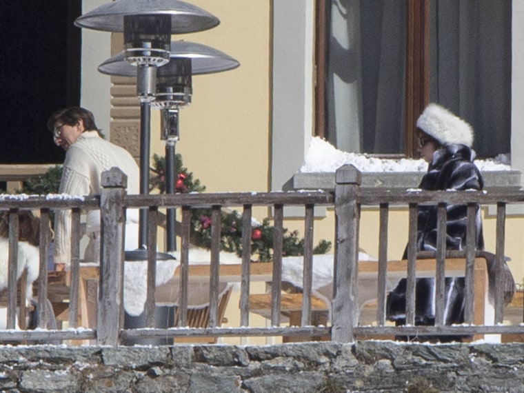 lady gaga and adam driver on a snowy balcony in italy near heat lamps