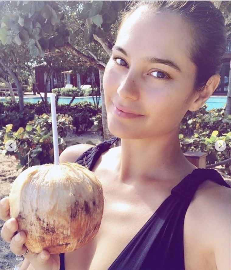 Moore shared a photo of Willis looking relaxed and drinking out of a coconut at the beach in honor of International Women's Day.