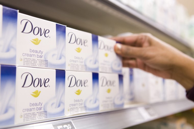 Image: A customer selects bar of Dove soap, a Unilever product, at a Sainsbury's supermarket in London, U.K.