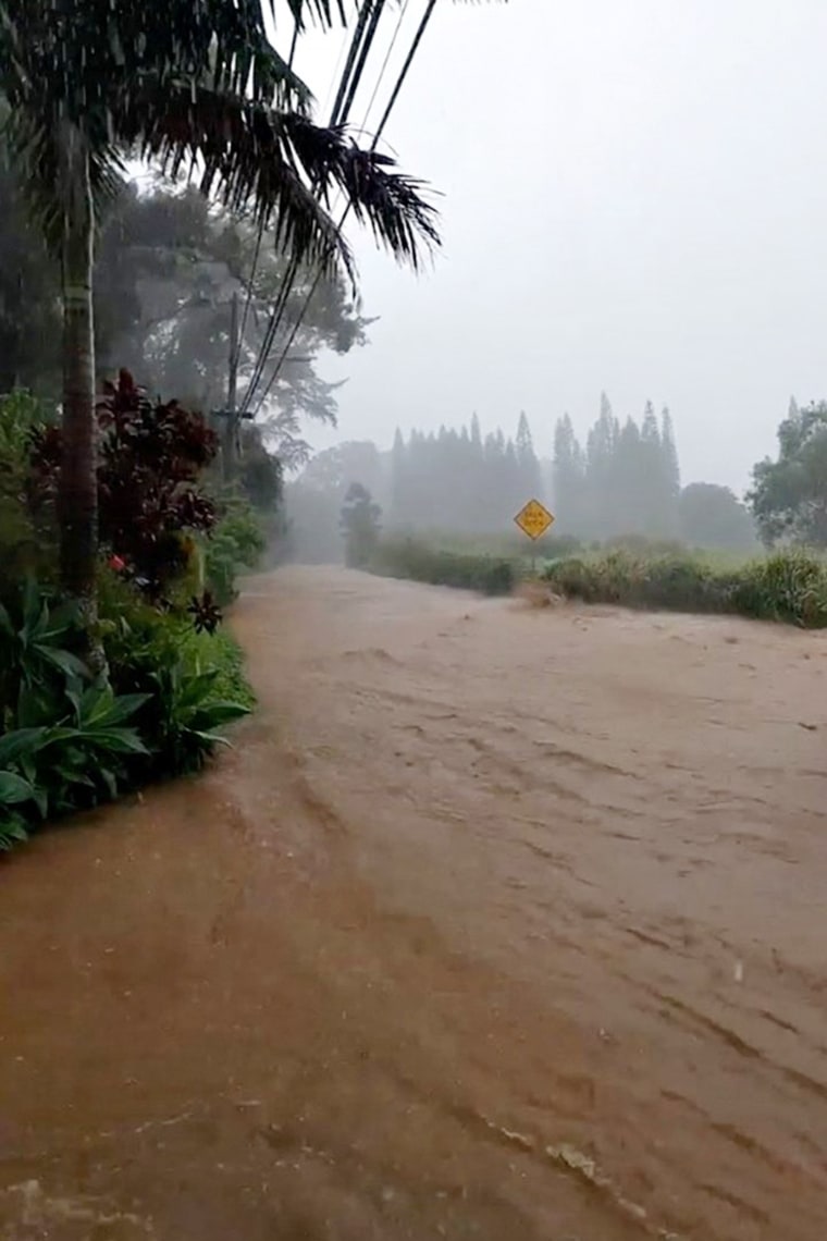 Image: A flooded road near the breached Kaupakalua Dam on Maui