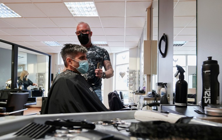 Image: A customer has his hair cut at a hairdresser in Kobavogur, Iceland