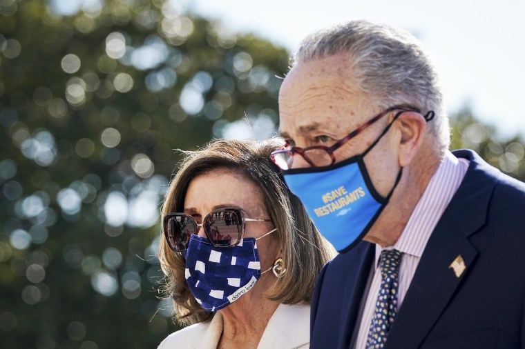 Speaker of the House Nancy Pelosi and Senate Majority Leader Chuck Schumer depart after they signed the $1.9 trillion Covid-19 relief bill during a bill enrollment ceremony in Washington on March 10, 2021.